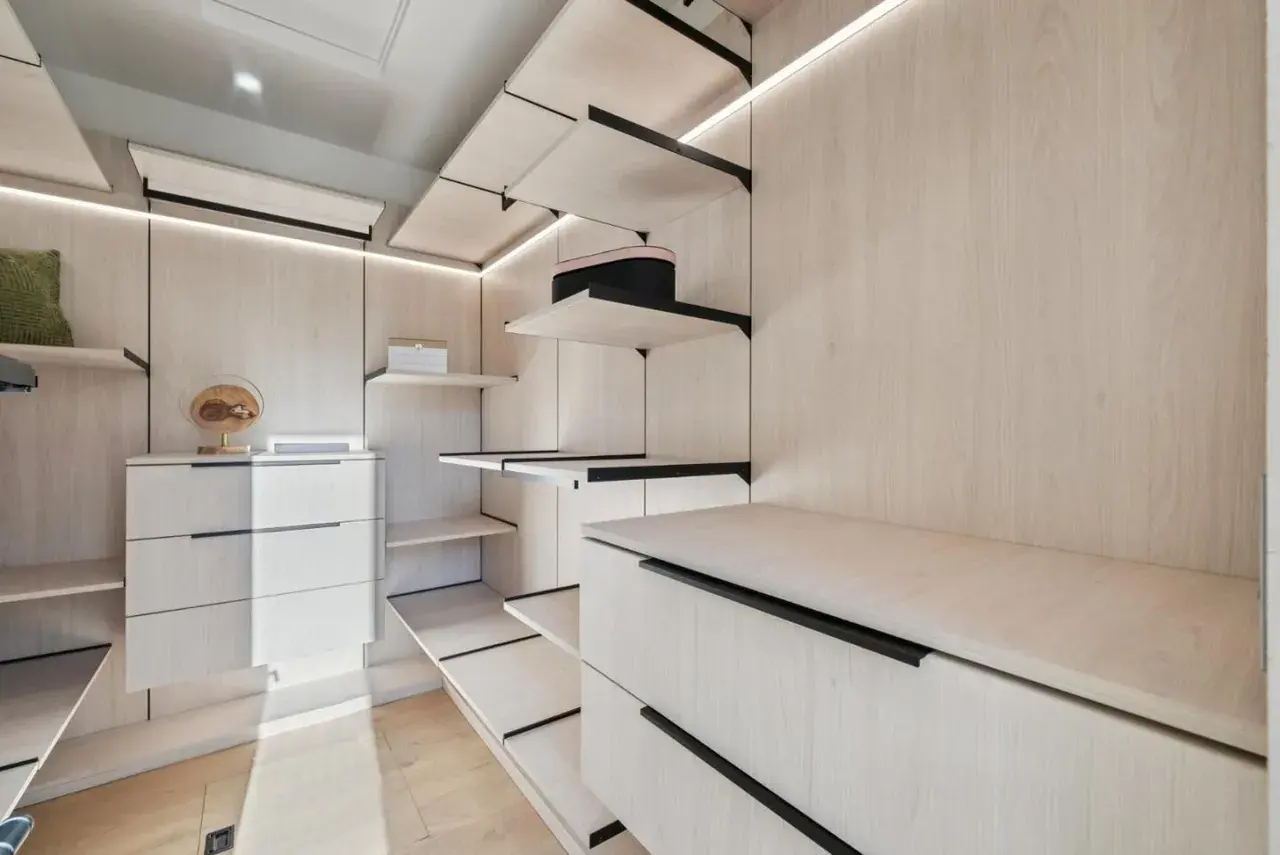 Dressing room with LED strip lighting under each shelf