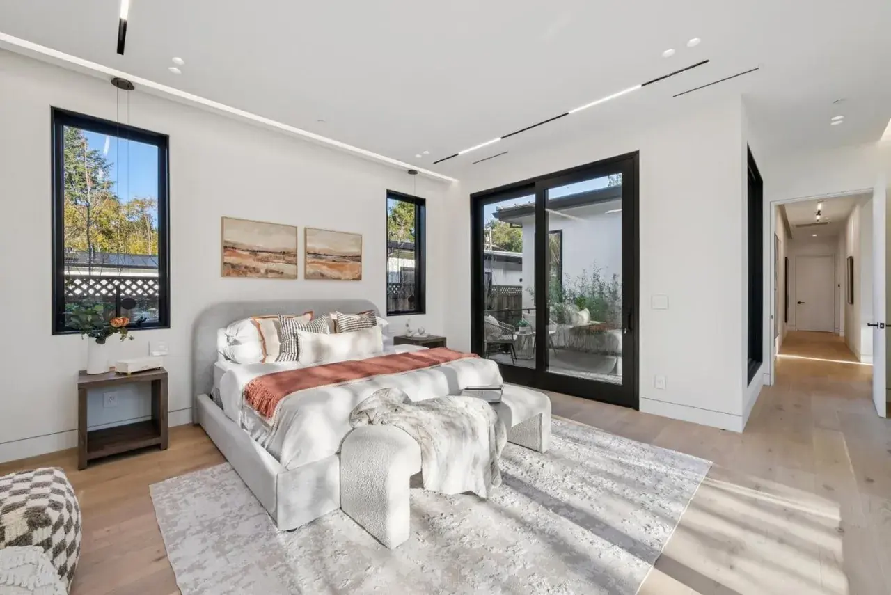 Bedroom with black framed windows either side of the bed