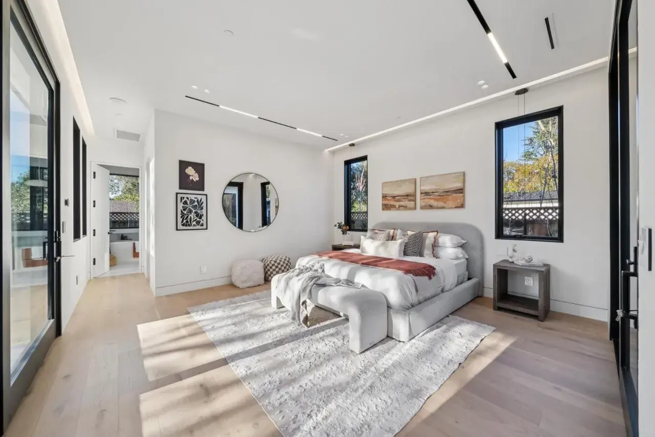 Bedroom with a fireplace and a seating corner
