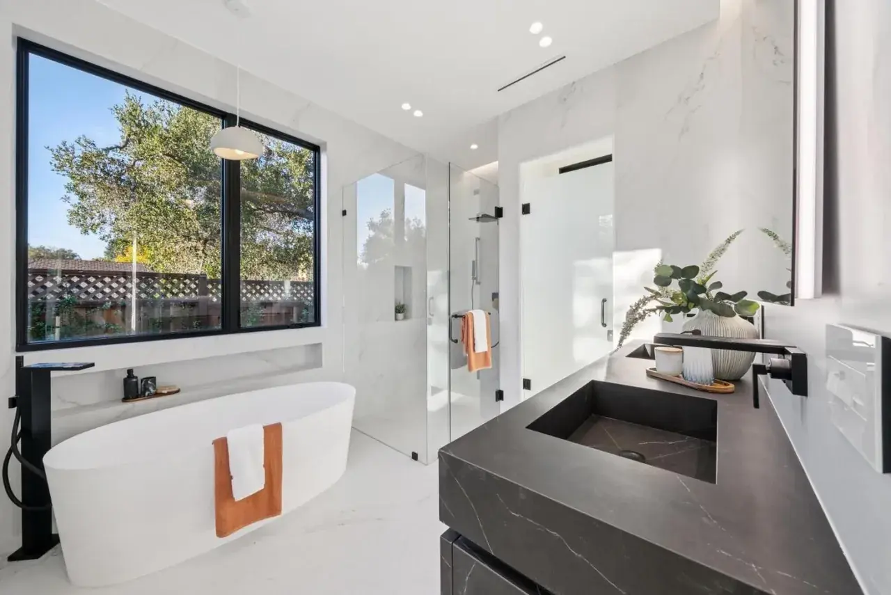 Bathroom with a freestanding tub beside the window