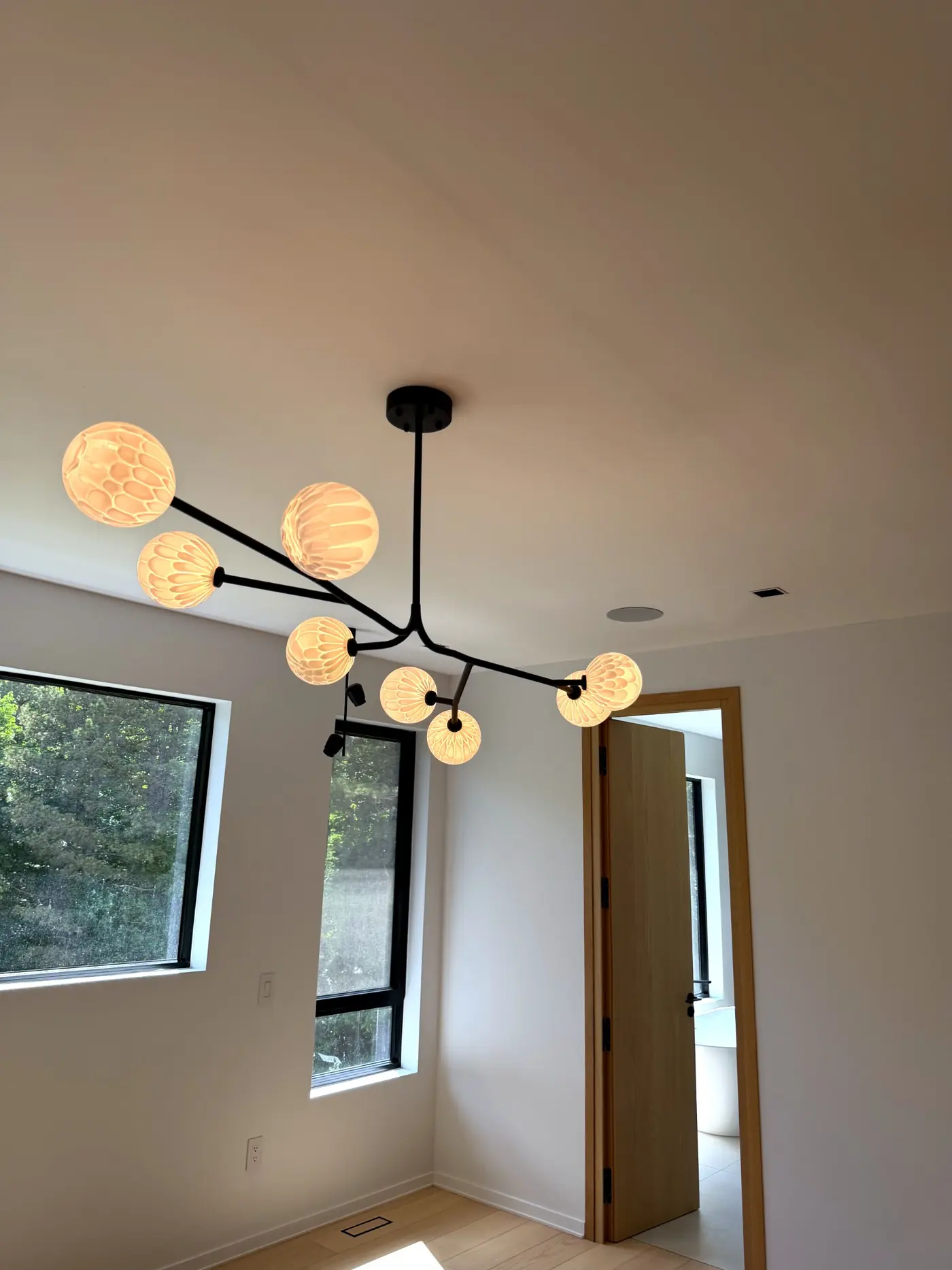 Bedroom with a branch chandelier and globe shades