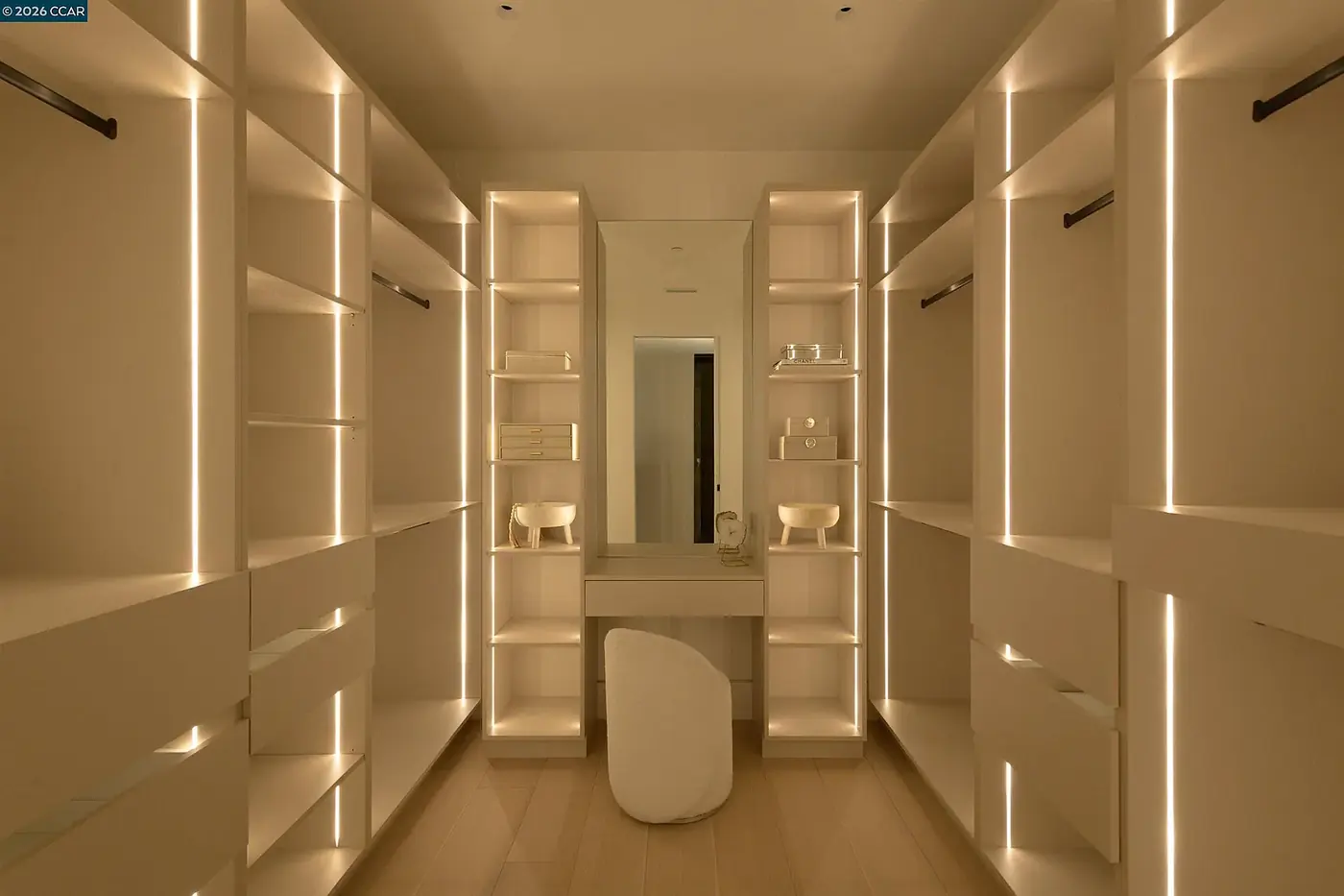 Dressing room lit by vertical LED strips between the cabinetry bays