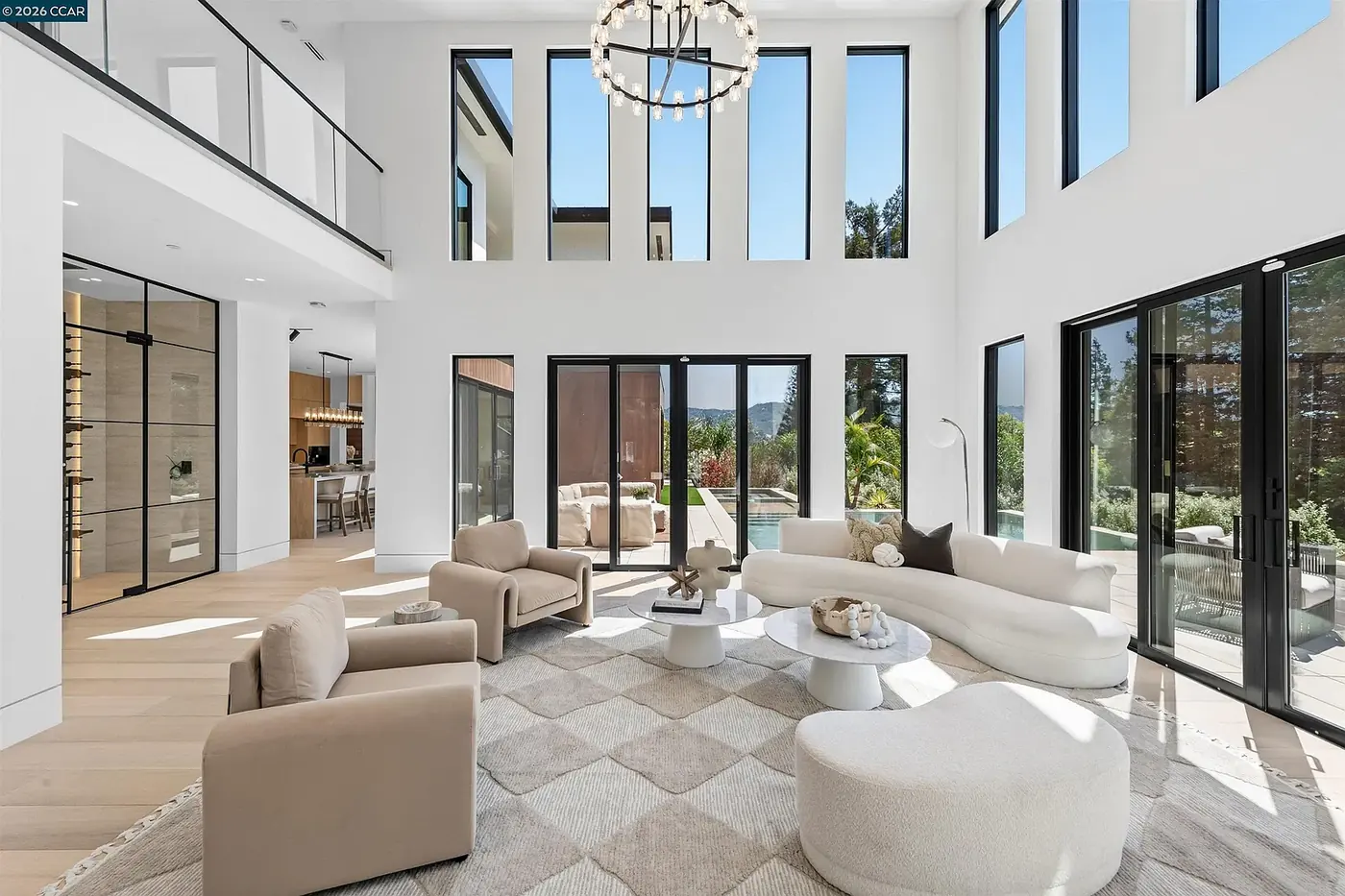 Double height living space with a globe chandelier and clerestory glazing