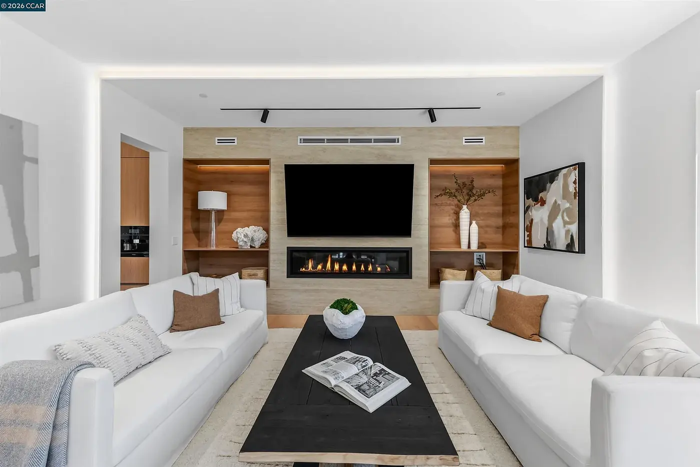 Living room with a media wall and recessed downlights above