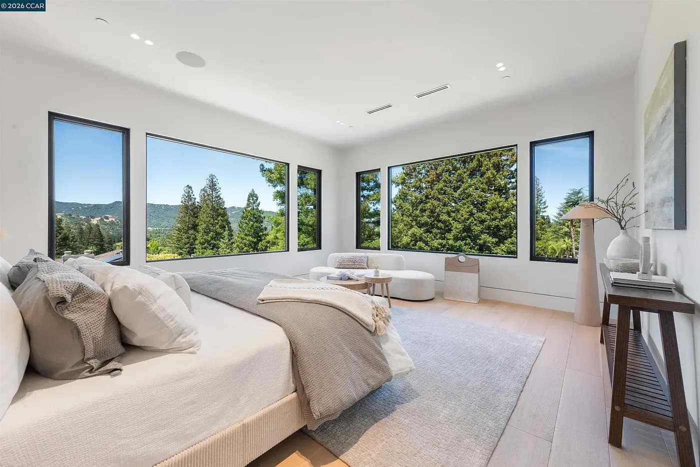 Primary bedroom with windows to the hillside